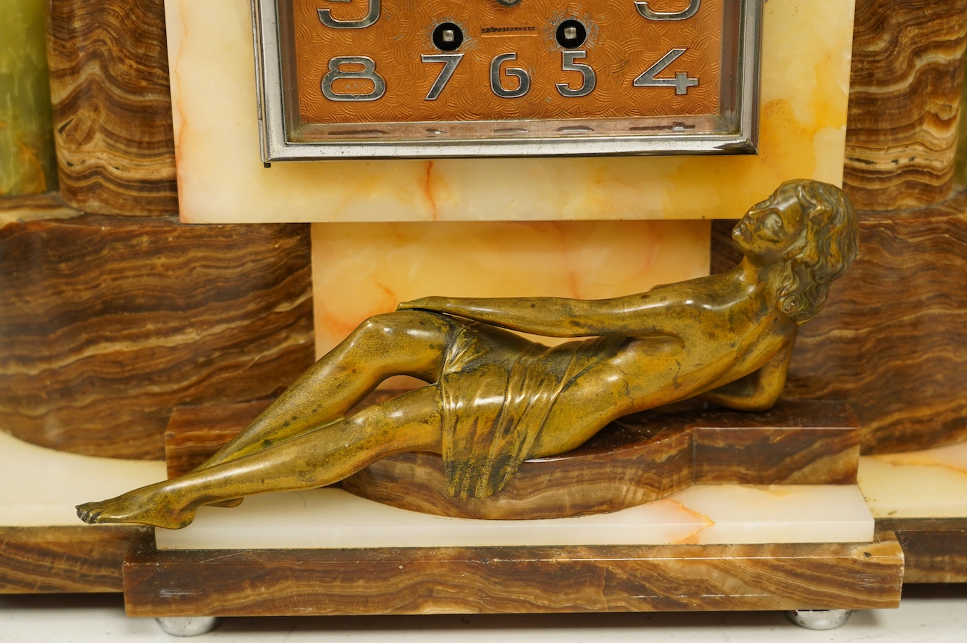 An Art Deco onyx and bronze figural clock, 27cm high. Condition - fair